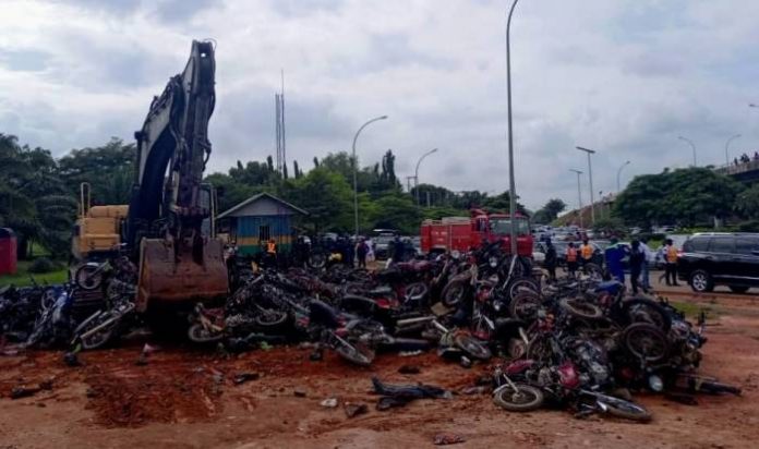 Some-of-the-impounded-motorcycles-being-crushed-around-Area-1-Roundabout-in-Abuja-on-Thursday